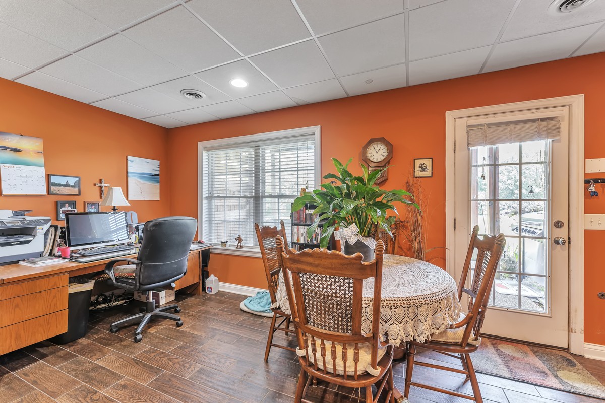 457 Bowling Branch Road Cottontown, TN 37048 - Photo 28 of 38 a dining room with furniture a potted plant and wooden floor