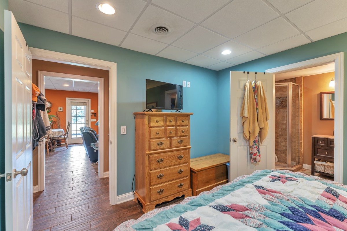 457 Bowling Branch Road Cottontown, TN 37048 - Photo 30 of 38 a bedroom with furniture and a wooden floor