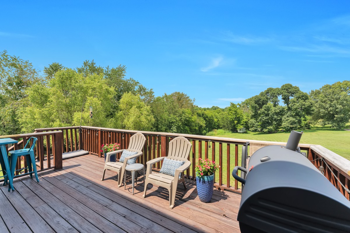 457 Bowling Branch Road Cottontown, TN 37048 - Photo 32 of 38 a view of a balcony with wooden floor and outdoor seating