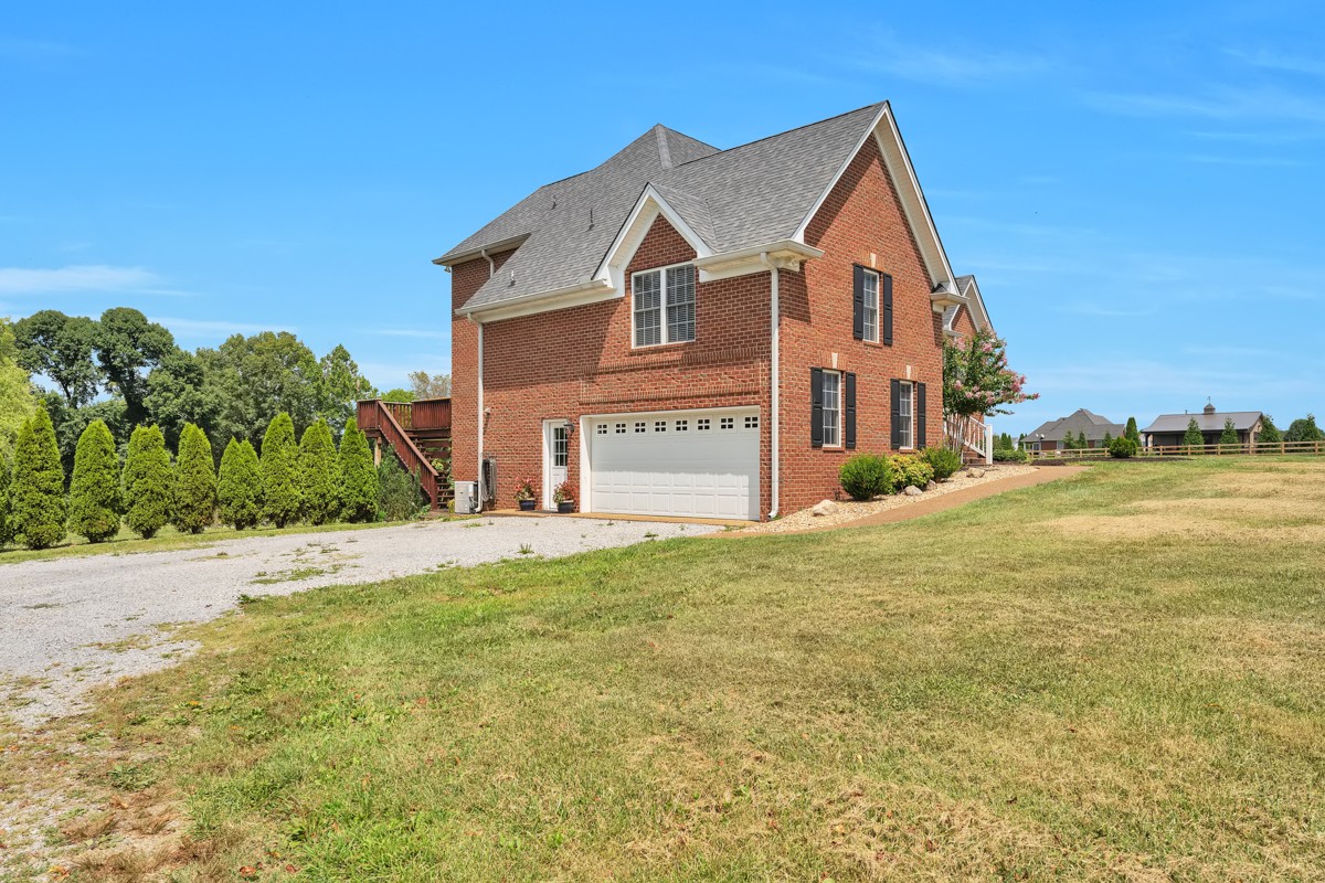 457 Bowling Branch Road Cottontown, TN 37048 - Photo 5 of 38 a front view of a house with a yard and garage