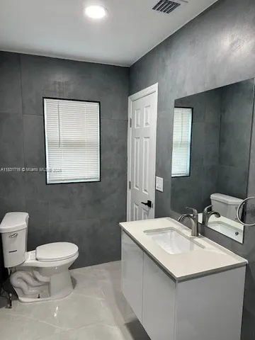 a bathroom with a sink a toilet a shower and a mirror