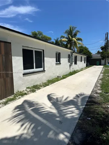 a backyard of a house with oven and potted plants