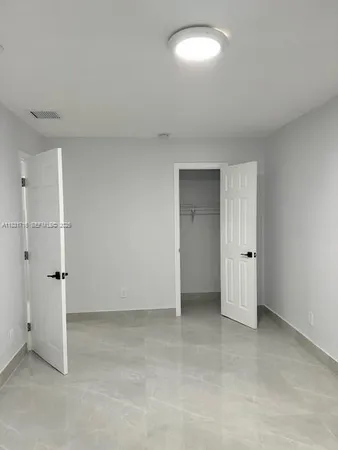 a bathroom with a sink a toilet a shower and a window