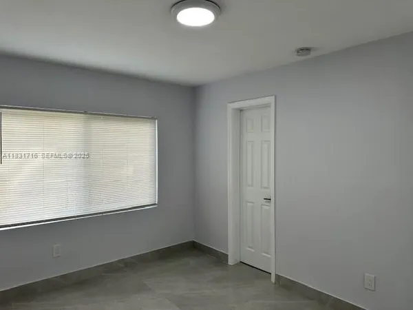 a kitchen with a sink cabinets stainless steel appliances and a window