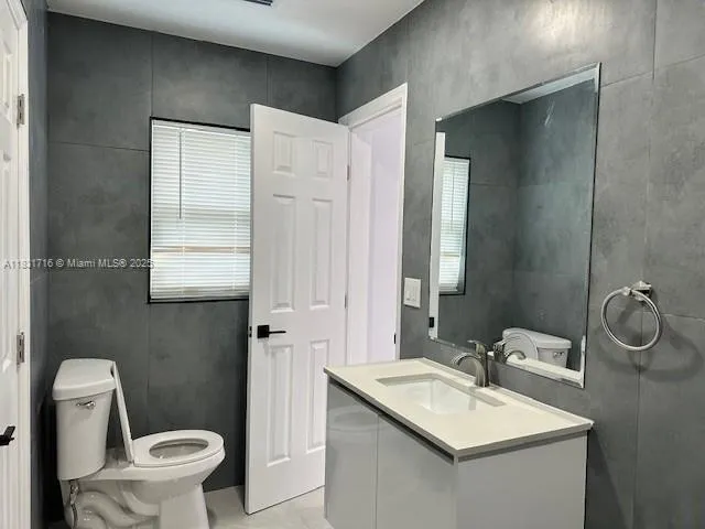 a bathroom with a sink a shower and a mirror