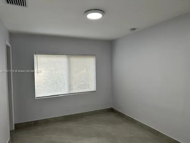 a kitchen with refrigerator and cabinets