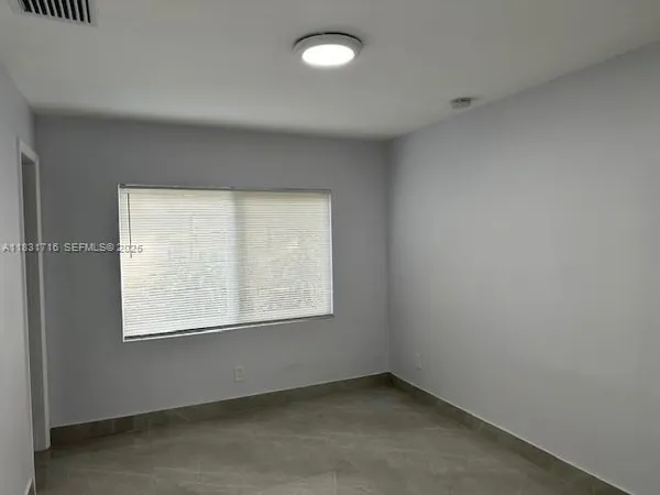 a view of empty room with a fireplace