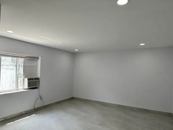 a view of an empty room with a window