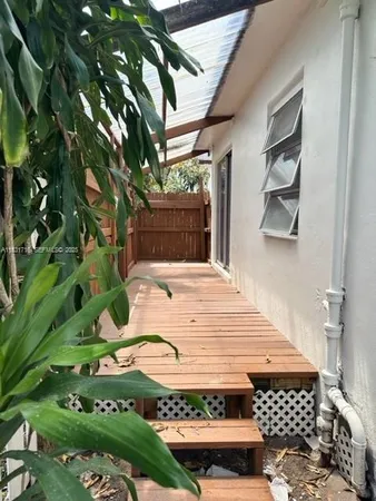 a backyard of a house with plants and trees