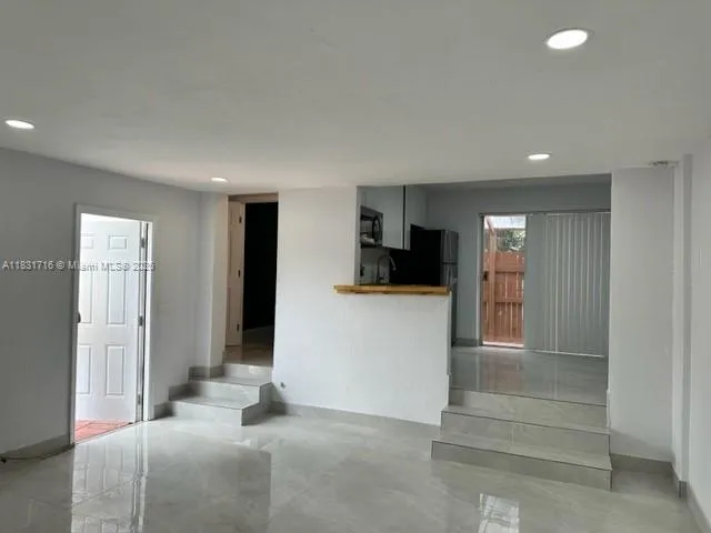 a bathroom with a shower and a sink