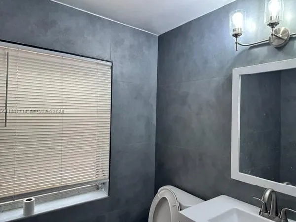 a bathroom with a shower and a sink