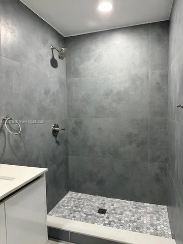 a kitchen with stainless steel appliances a refrigerator sink and cabinets