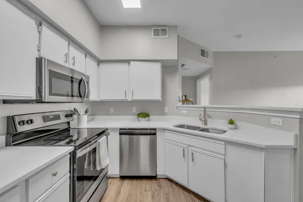 a kitchen with a sink stainless steel appliances and cabinets