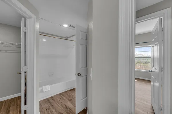 a bathroom with a sink toilet vanity and tub
