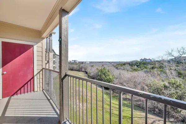 a view of a balcony with wooden fence and floor