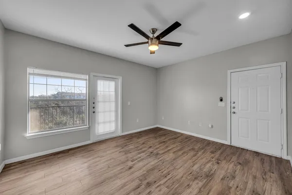 wooden floor in an empty room with a window