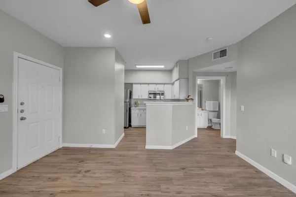 a living room with furniture and kitchen view