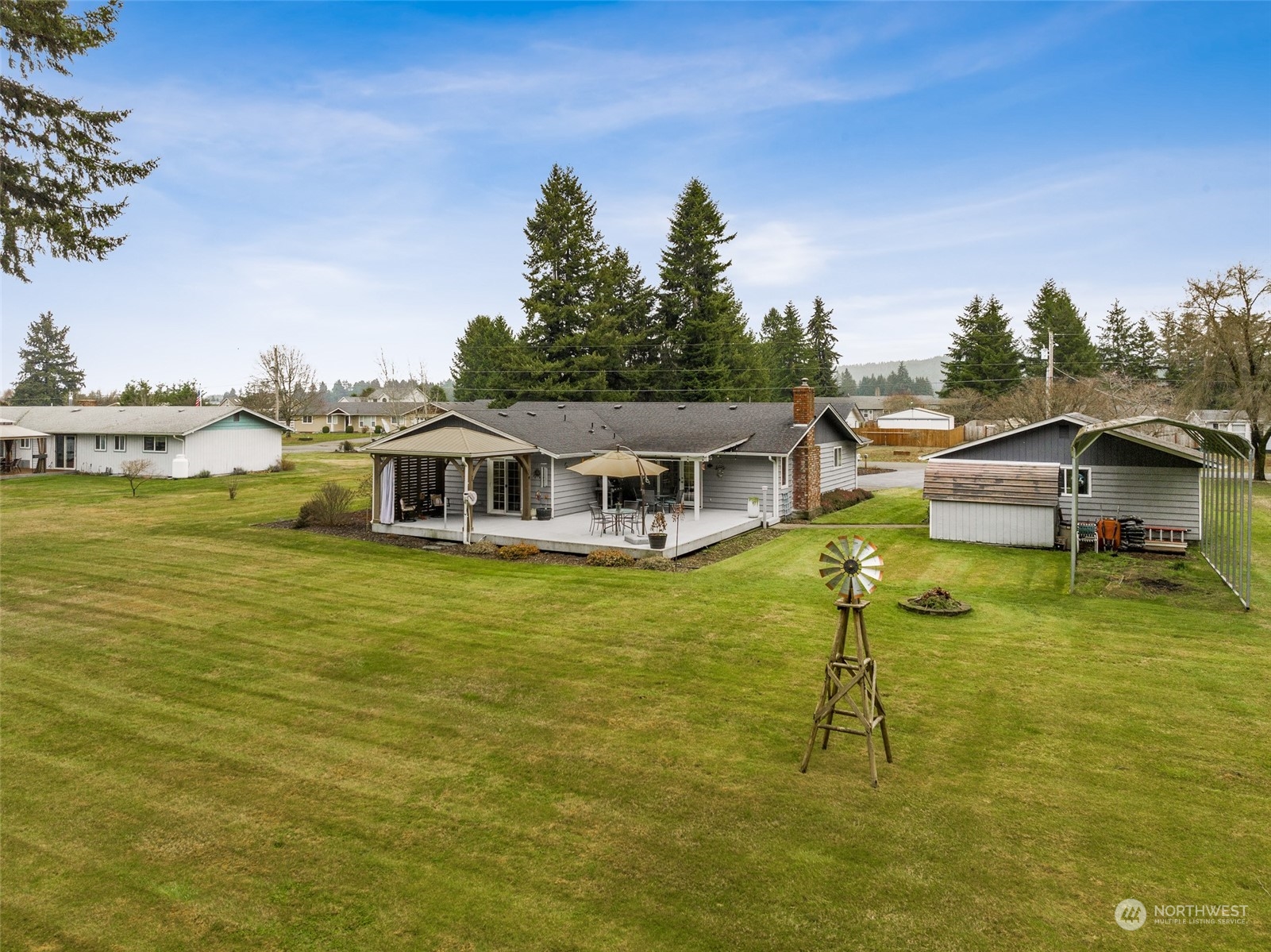18921 Nutmeg Street Southwest Rochester, WA 98579 - Photo 25 of 32 a house view with swimming pool and trees in the background