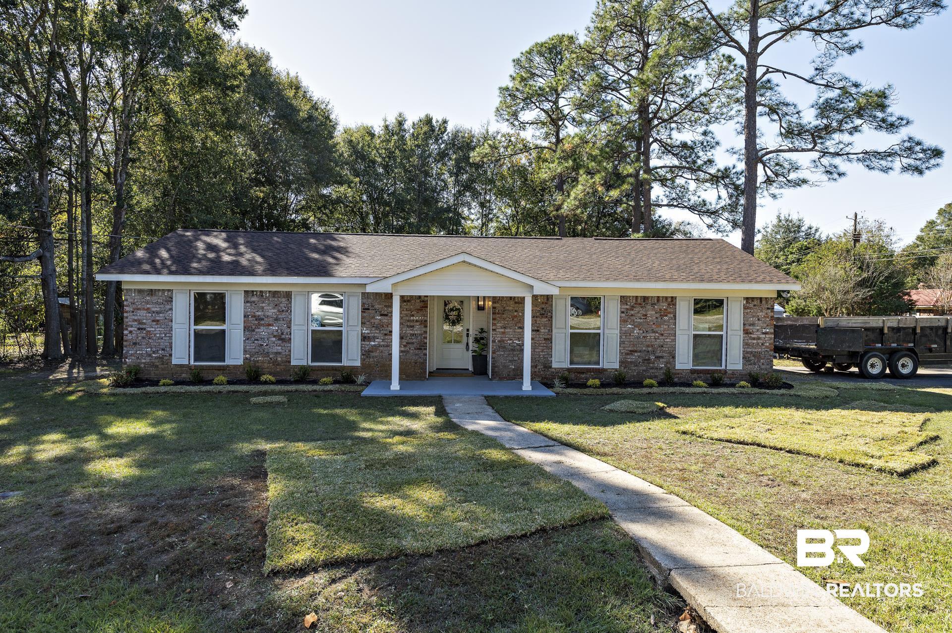 6001 Camp Halls Mill Road Mobile, AL 36619 - Photo 51 of 52 Ranch-style house with a porch, brick siding, roof with shingles, and a front yard