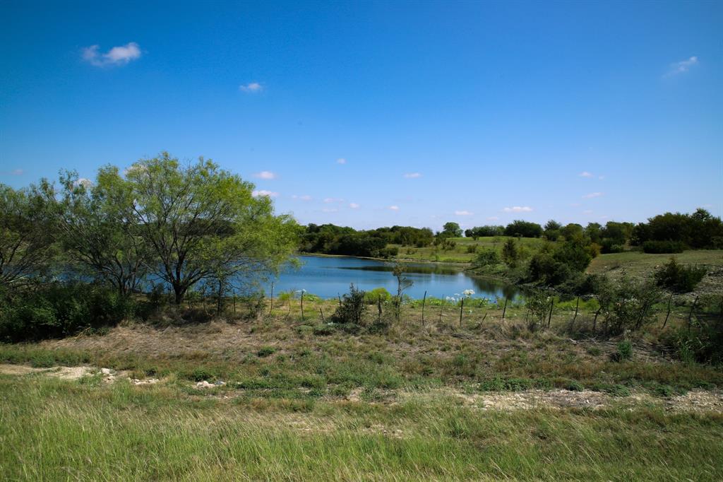 1365 Doty Road Cleburne, TX 76033 - Photo 20 of 26 a view of a lake with a house in the background