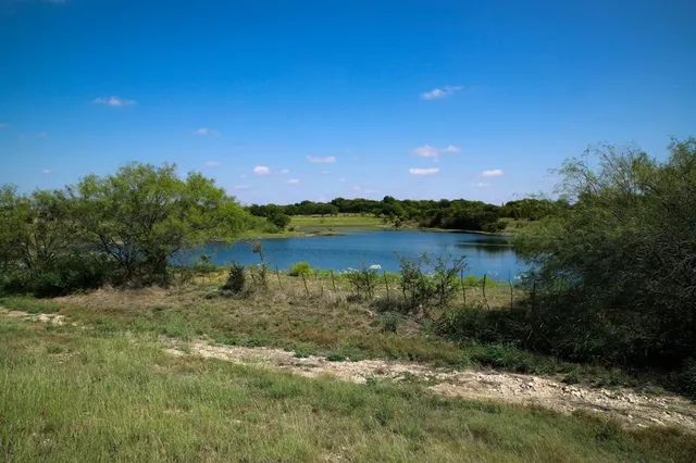 a view of a lake with houses in the back