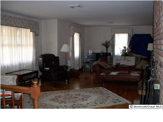 66 Clearstream Road Lakewood, NJ 08701 - Photo 3 of 3 a living room with furniture a window and a fireplace