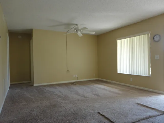 an empty room with windows and closet