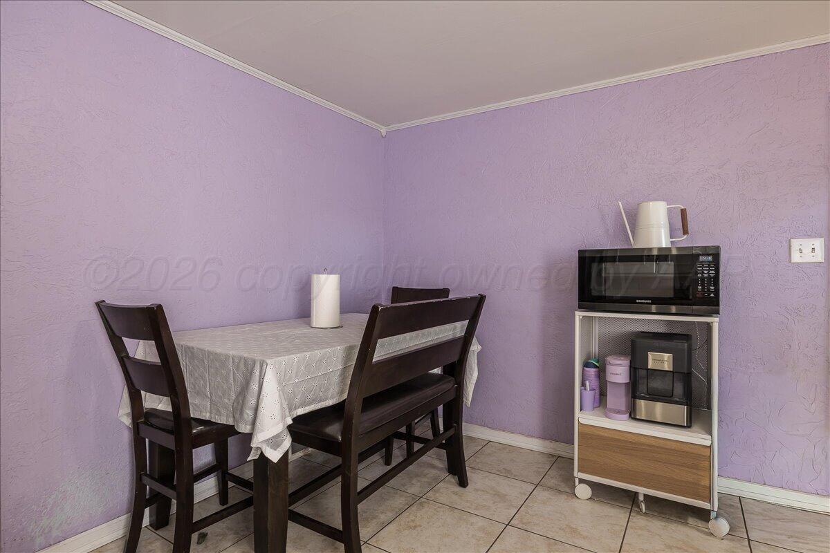 4011 Parker Street Amarillo, TX 79110 - Photo 8 of 17 a view of a dining room with furniture and wooden floor