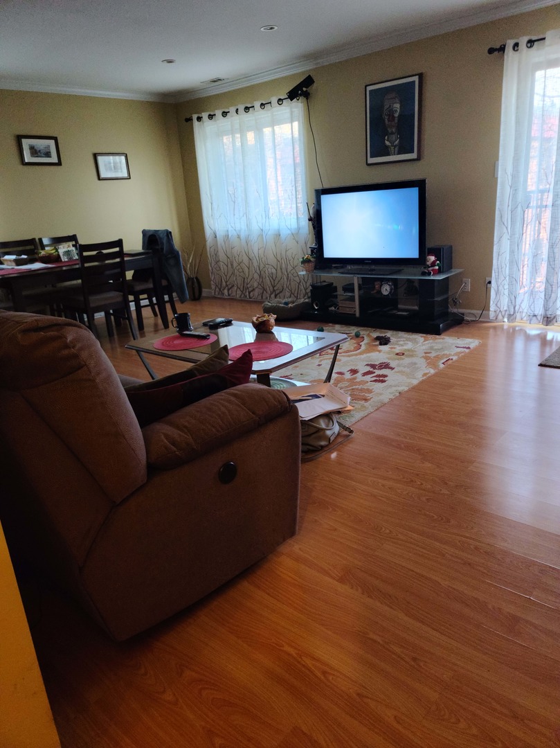 1771 West Algonquin Road, Unit 3B Mount Prospect, IL 60056 - Photo 3 of 17 a living room with furniture and a flat screen tv