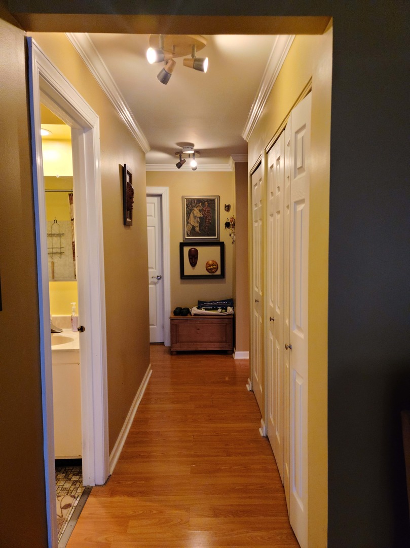 1771 West Algonquin Road, Unit 3B Mount Prospect, IL 60056 - Photo 8 of 17 a view of a hallway view with wooden floor and furniture