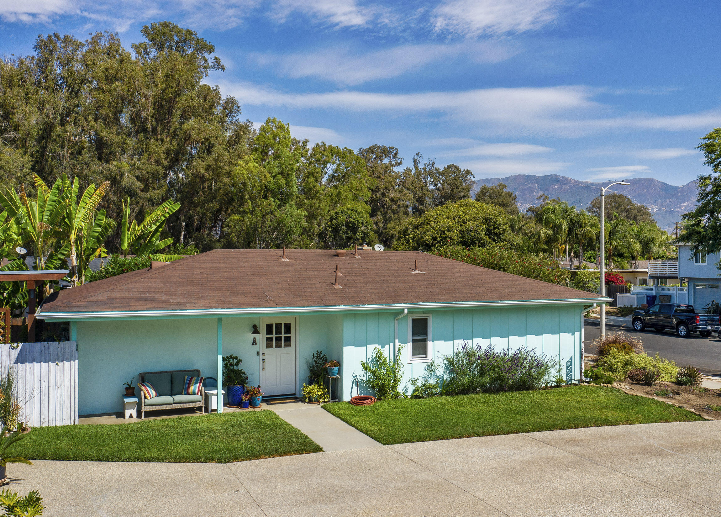 a view of a garden with a house in the background