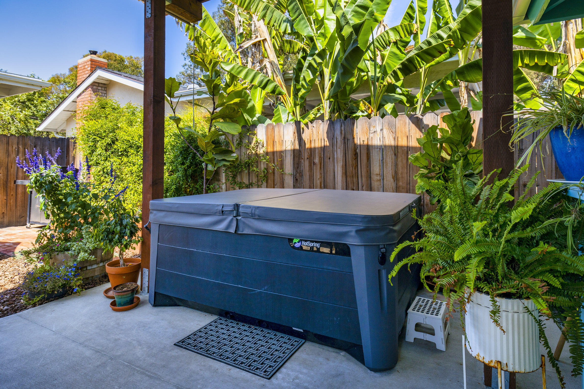 231 Ribera Drive, Unit A Santa Barbara, CA 93111 - Photo 7 of 18 a view of a wooden door and a table under an umbrella