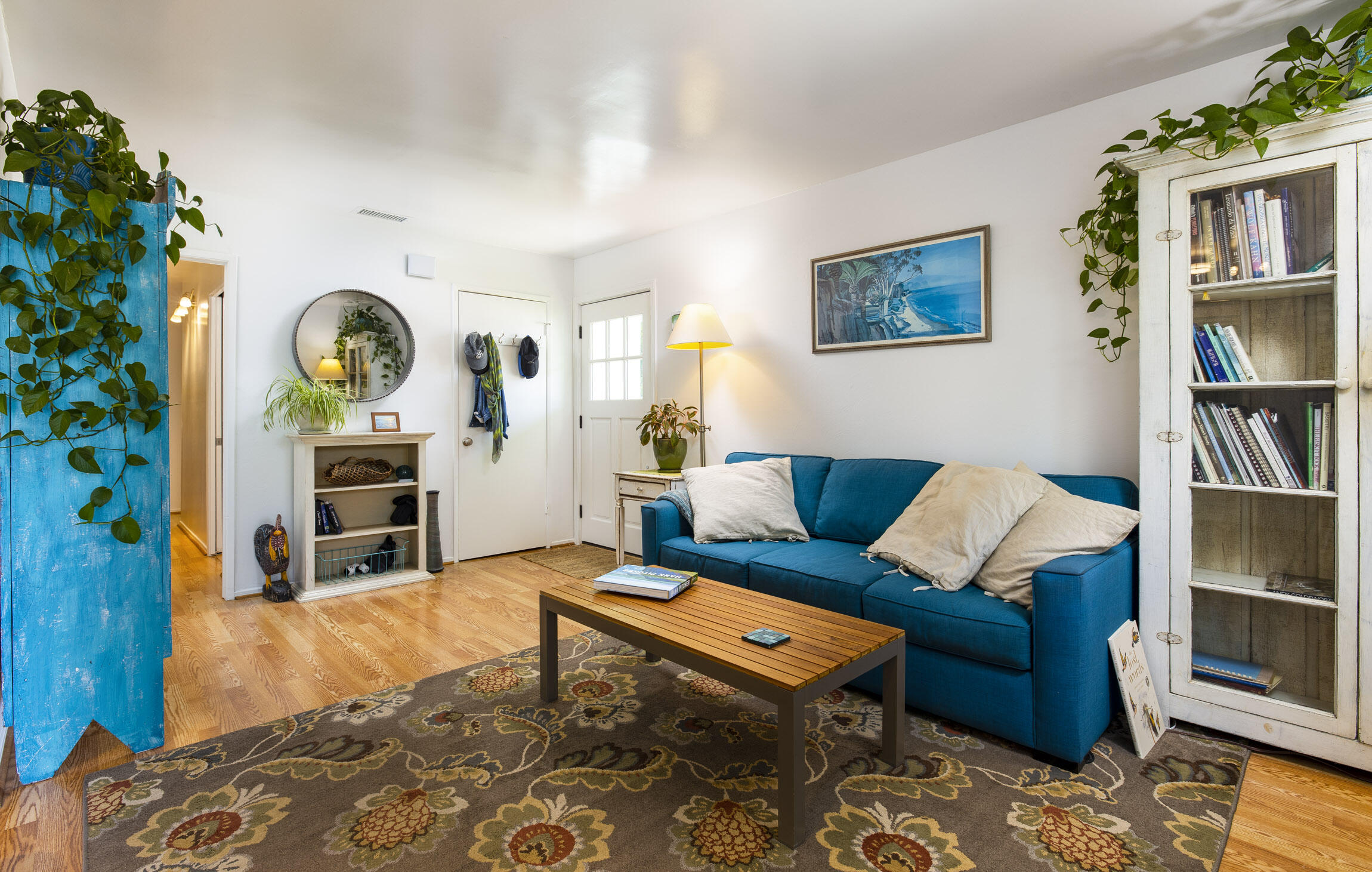231 Ribera Drive, Unit A Santa Barbara, CA 93111 - Photo 9 of 18 a living room with furniture a rug and a bookshelf