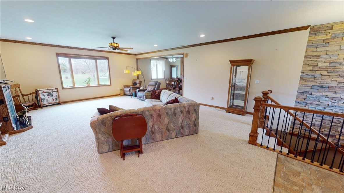 10323 Smith Road Litchfield, OH 44253 - Photo 5 of 50 Living area featuring crown molding, light carpet, baseboards, ceiling fan, and recessed lighting