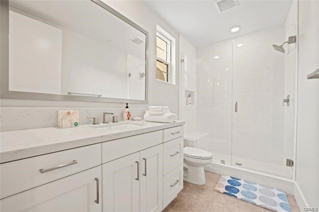 63 Cetus Irvine, CA 92618 - Photo 7 of 7 a view of bathroom with a sink a toilet a shower and a mirror
