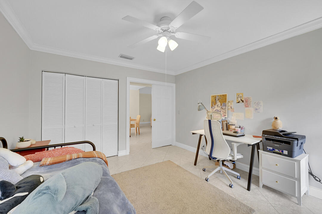 6245 Old Court Road, Unit 202 Boca Raton, FL 33433 - Photo 13 of 41 a bedroom with a bed and a chandelier