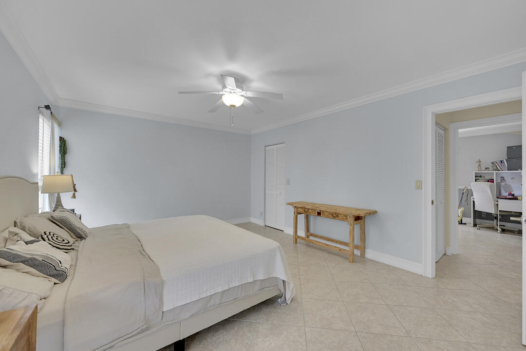 6245 Old Court Road, Unit 202 Boca Raton, FL 33433 - Photo 20 of 41 a bedroom with a bed and a lamp on table