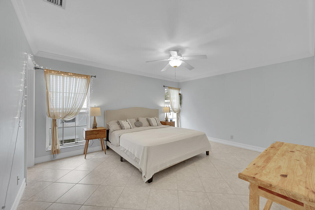 6245 Old Court Road, Unit 202 Boca Raton, FL 33433 - Photo 21 of 41 a bedroom with a bed and a chandelier