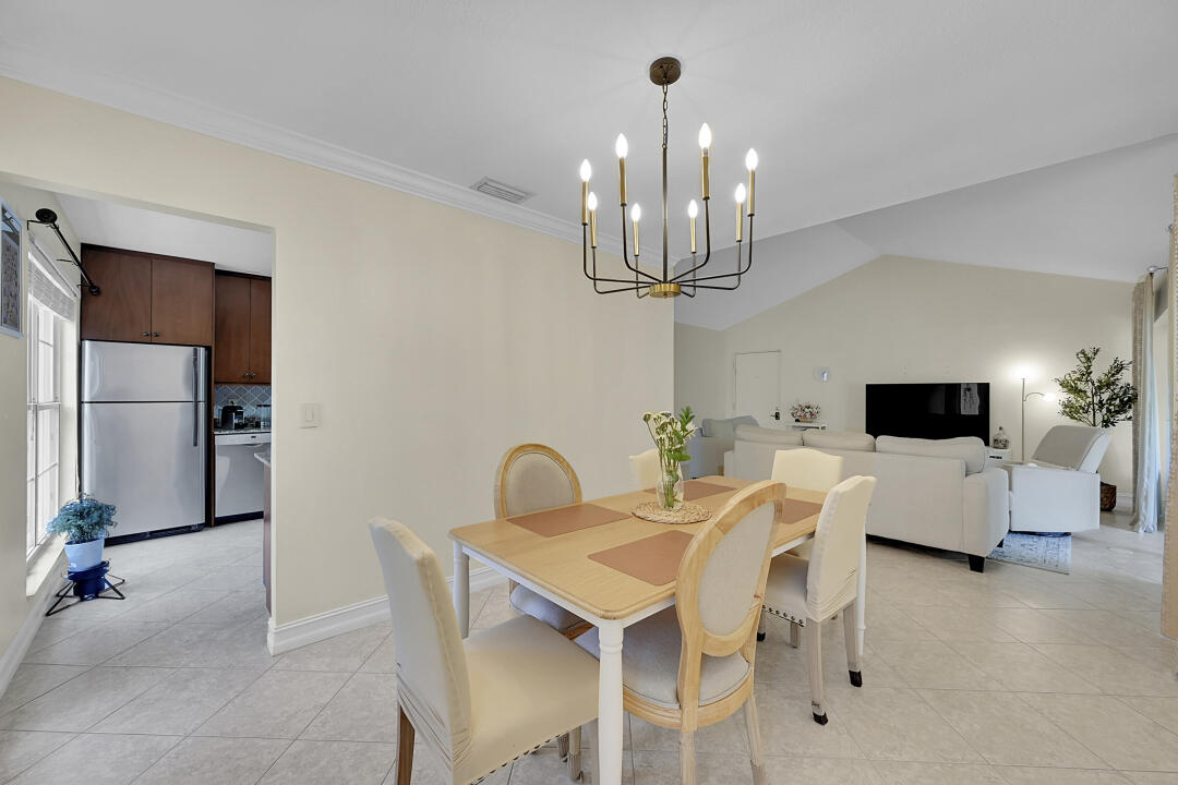 6245 Old Court Road, Unit 202 Boca Raton, FL 33433 - Photo 9 of 41 a view of a dining room with furniture a chandelier and kitchen view