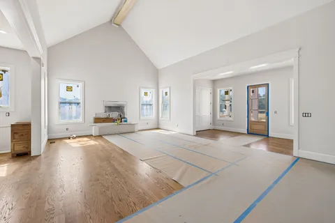 a view of a kitchen with white cabinets