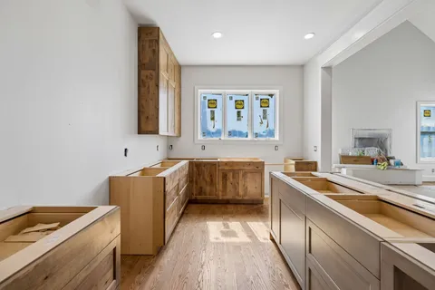 a kitchen with stainless steel appliances kitchen island granite countertop a refrigerator and a stove top oven
