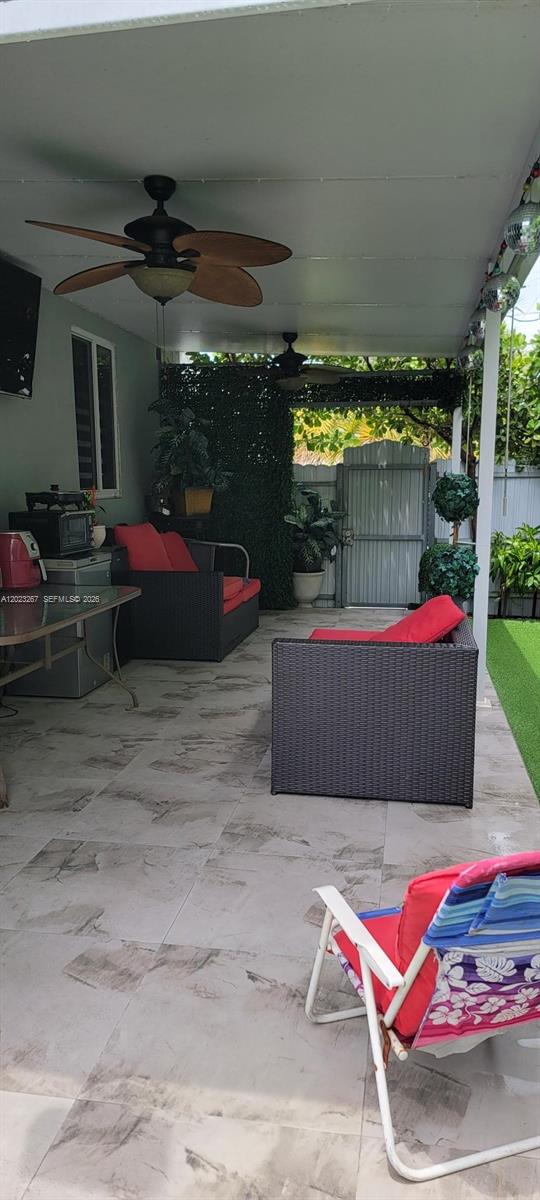 301 Southwest 36th Avenue Miami, FL 33135 - Photo 12 of 32 a view of a backyard with table and chairs potted plants