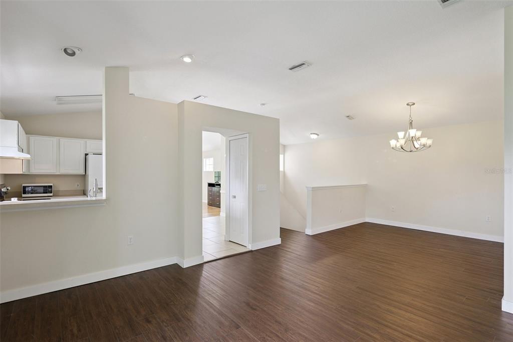 6412 Rosefinch Court, Unit 204 Lakewood Ranch, FL 34202 - Photo 15 of 33 a view of a kitchen with wooden floor and stainless steel appliances