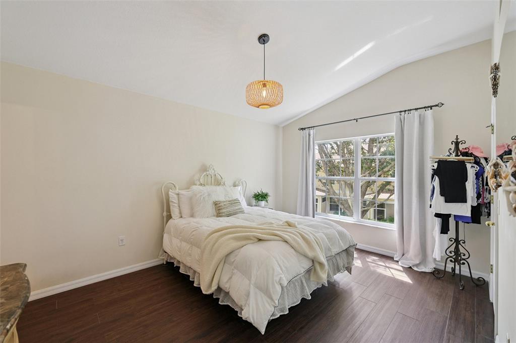 6412 Rosefinch Court, Unit 204 Lakewood Ranch, FL 34202 - Photo 16 of 33 a bedroom with a bed and wooden floor