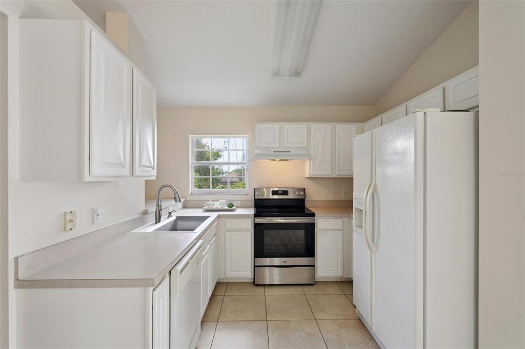 6412 Rosefinch Court, Unit 204 Lakewood Ranch, FL 34202 - Photo 23 of 33 a kitchen with a sink stove and refrigerator