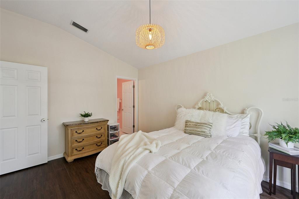 6412 Rosefinch Court, Unit 204 Lakewood Ranch, FL 34202 - Photo 26 of 33 a bedroom with a bed and a chandelier