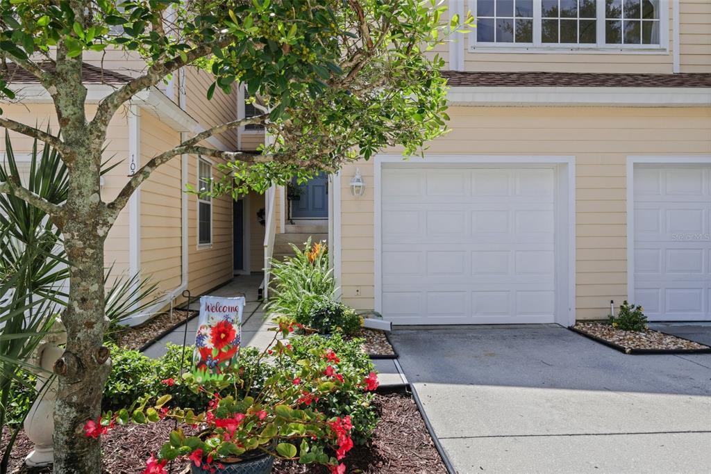 6412 Rosefinch Court, Unit 204 Lakewood Ranch, FL 34202 - Photo 29 of 33 a house with a flower garden in front of it