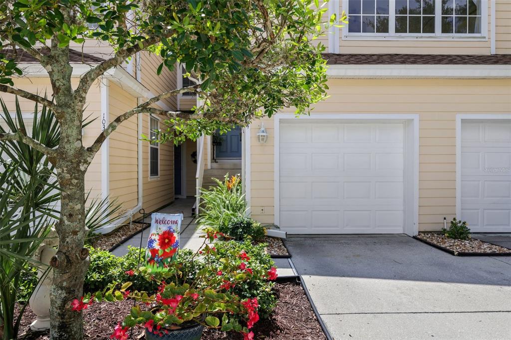 6412 Rosefinch Court, Unit 204 Lakewood Ranch, FL 34202 - Photo 30 of 33 a flower plants in front of a house
