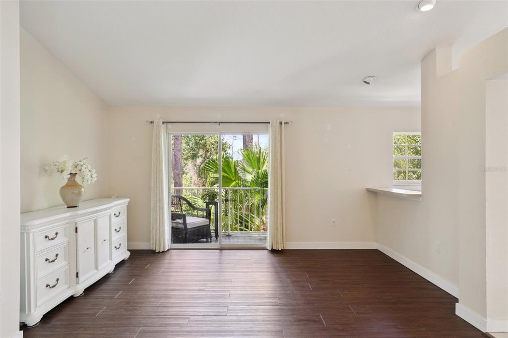 6412 Rosefinch Court, Unit 204 Lakewood Ranch, FL 34202 - Photo 10 of 33 wooden floor in an empty room with a window