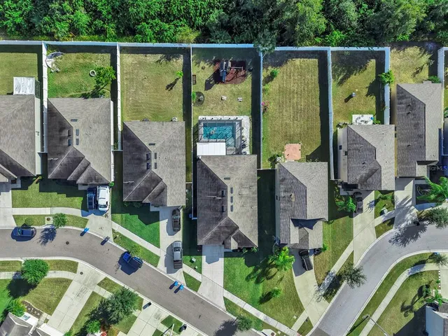 an aerial view of a house with swimming pool garden and patio